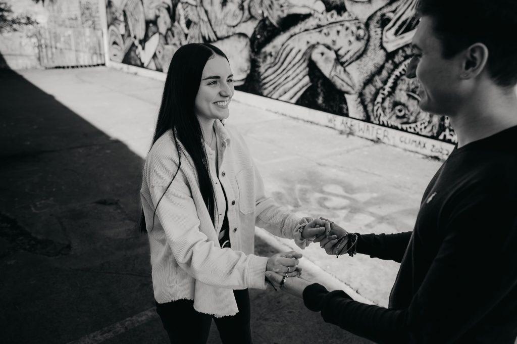 séance photo couple à Darwin, une femme souriante tient la main de son petit ami