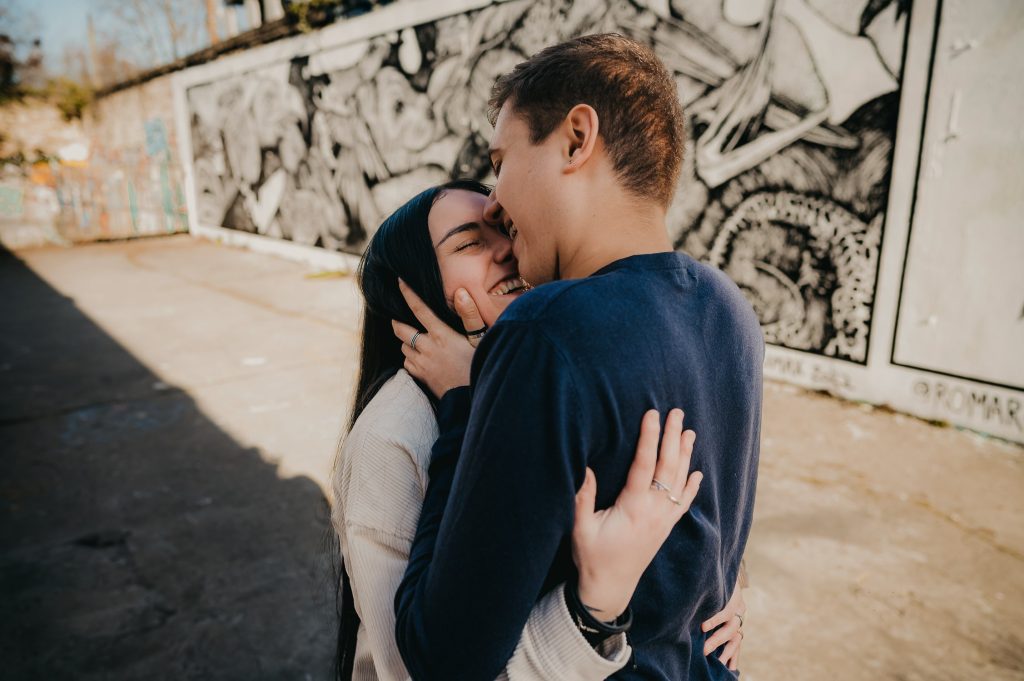 Jeune couple lors d'une séance photo à Bordeaux, tête contre tête ils se font un câlin