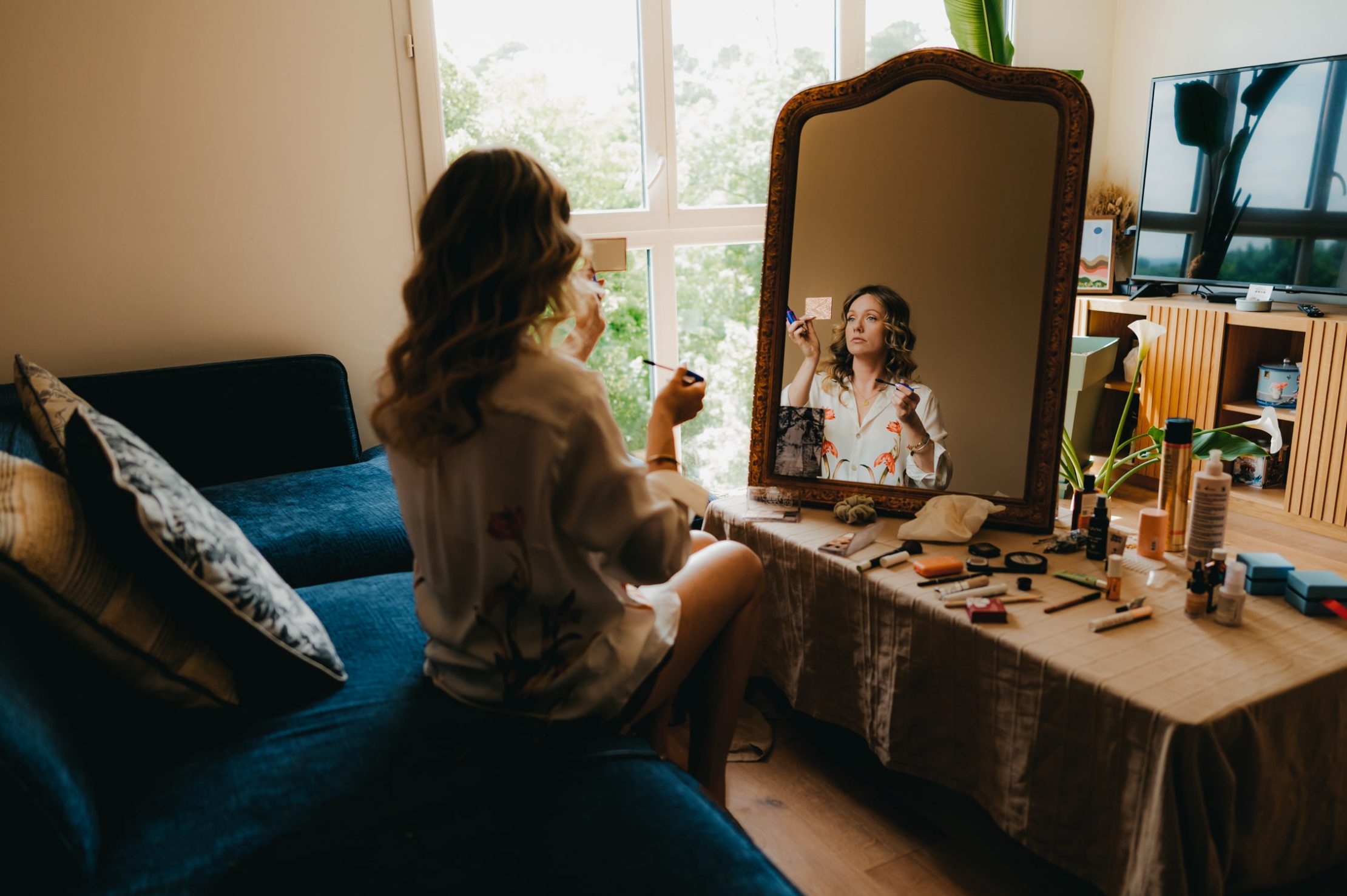une mariée qui se maquille devant son miroir